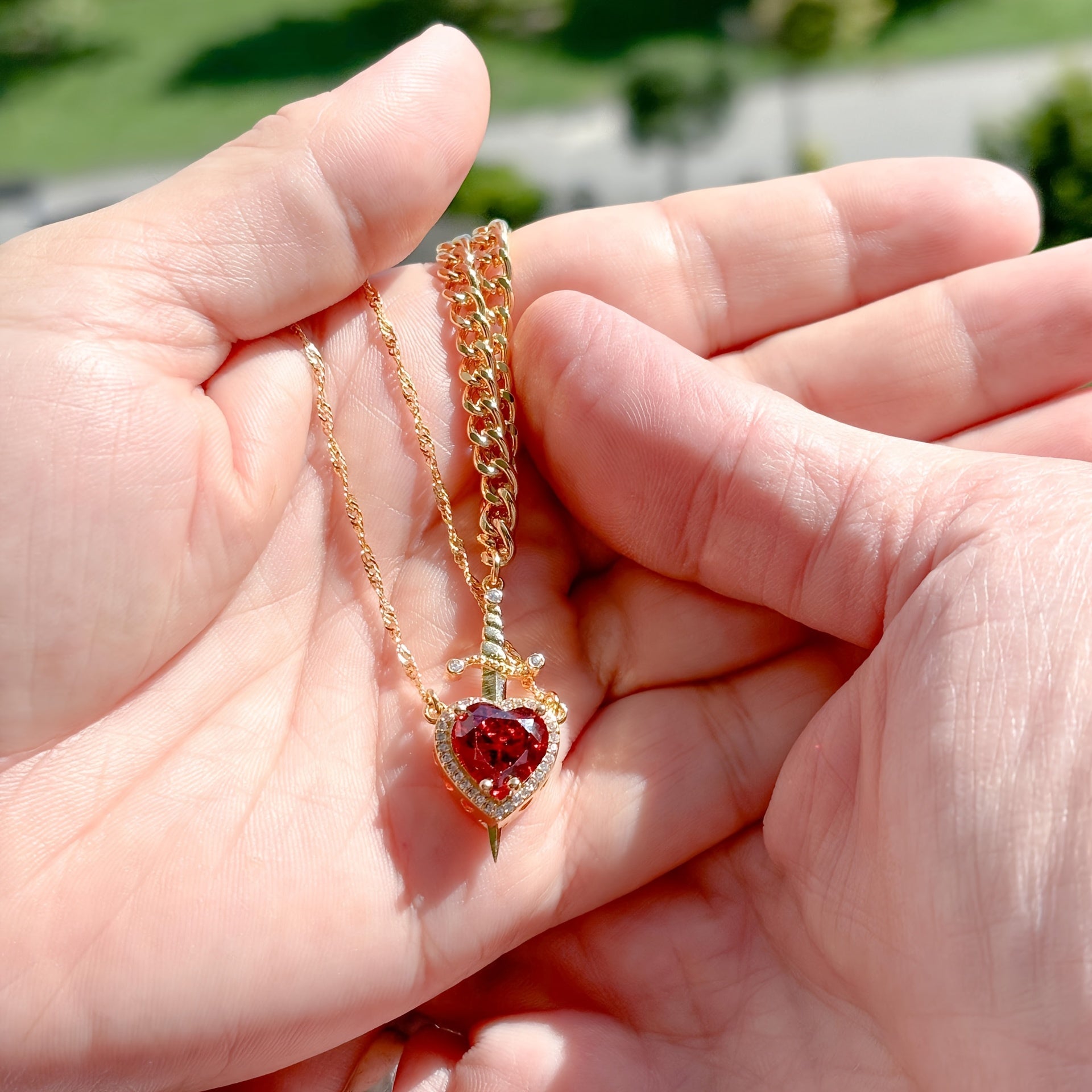 Close-up photo of Heart and Sword Necklace showing pendant and chain details