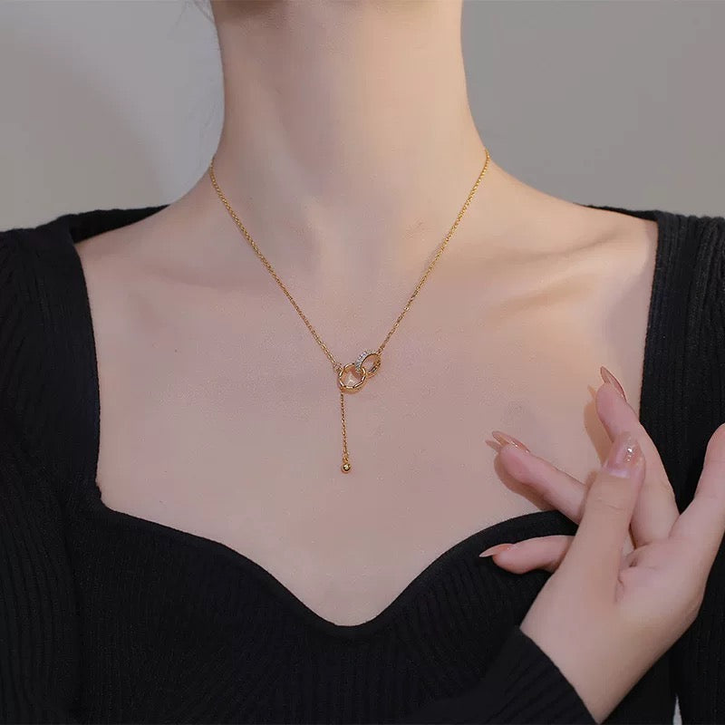Model wearing the Interlocking Circle Tassel Necklace, front view