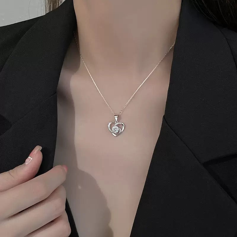 Model wearing Forever Rose heart necklace, subtle sparkle