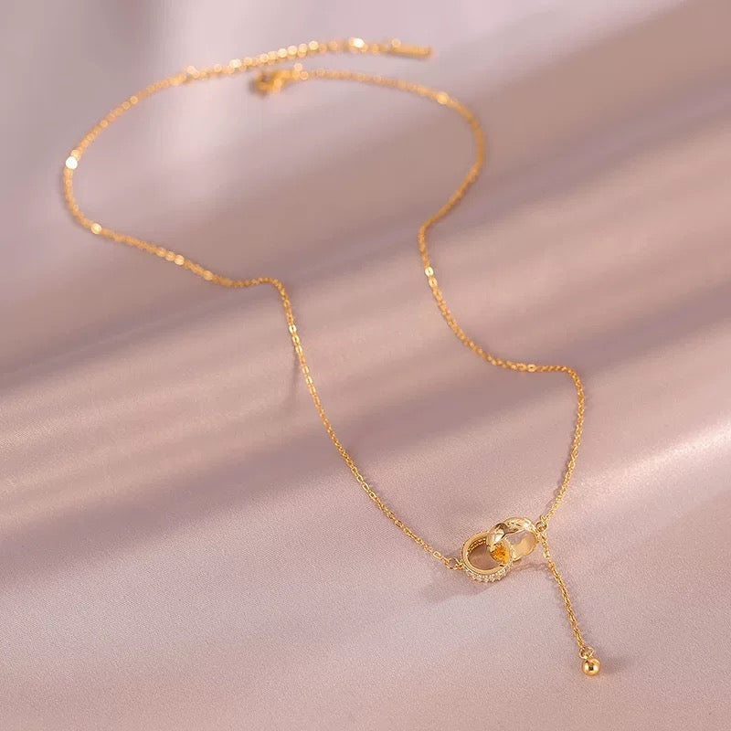 Model wearing the necklace, side view showing tassel movement