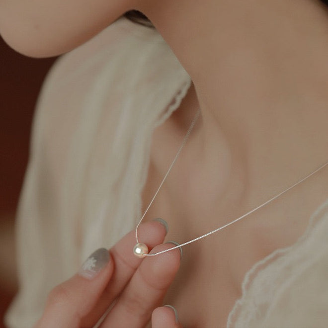 Lifestyle image featuring Eternal Pearl Necklace with elegant outfit