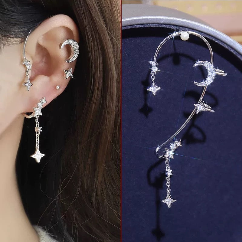 Model wearing Star and Moon Earrings with celestial design under soft lighting