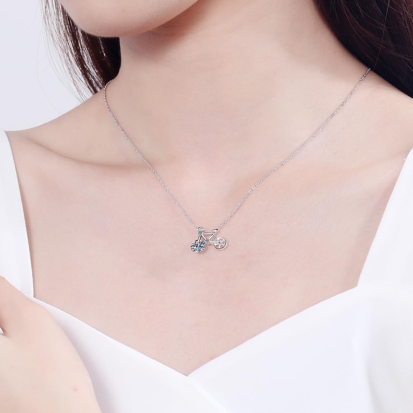 Model wearing Bicycle Necklace with casual outfit, highlighting playful spinning wheel design