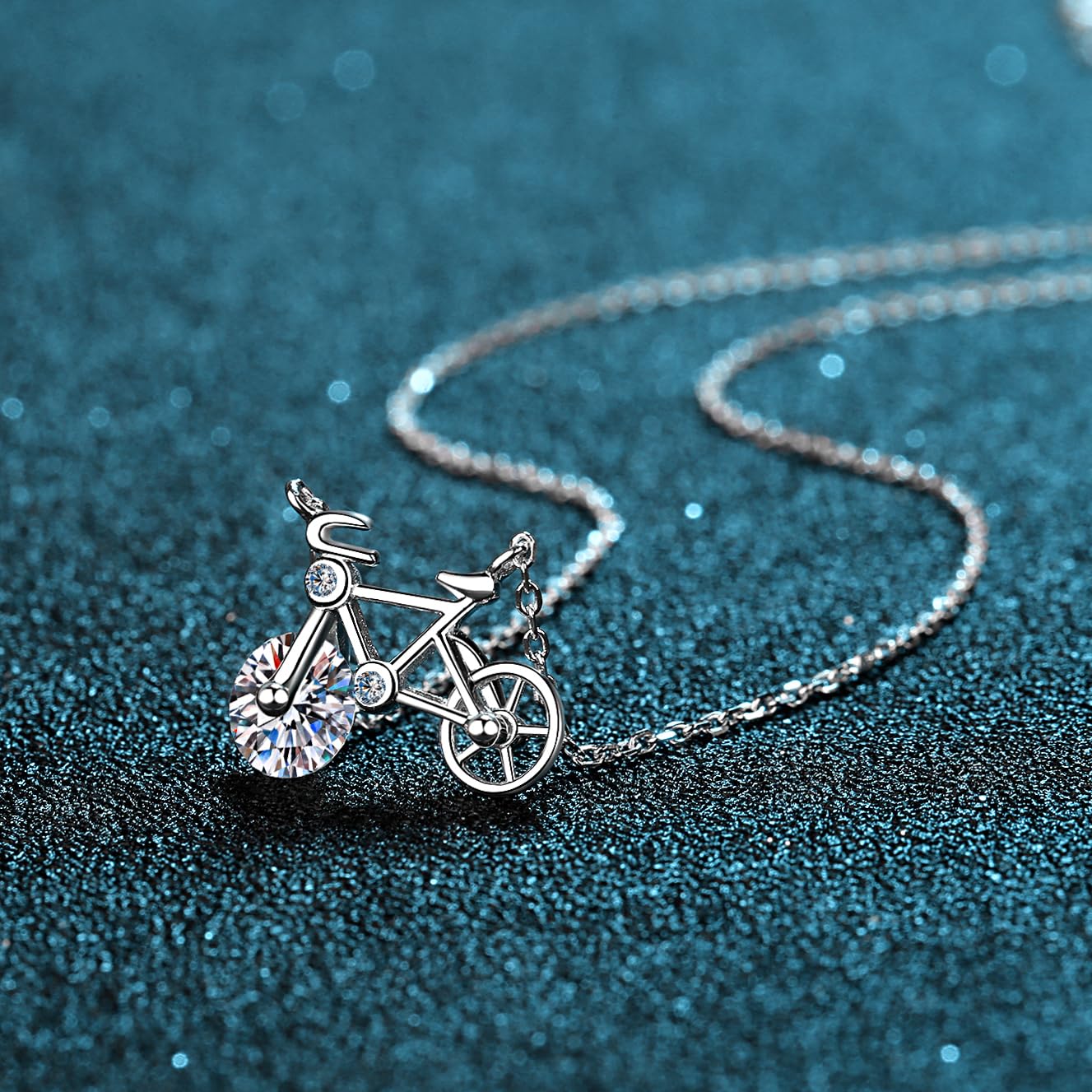Close-up of Bicycle Necklace moissanite pendant and spinning wheel detail