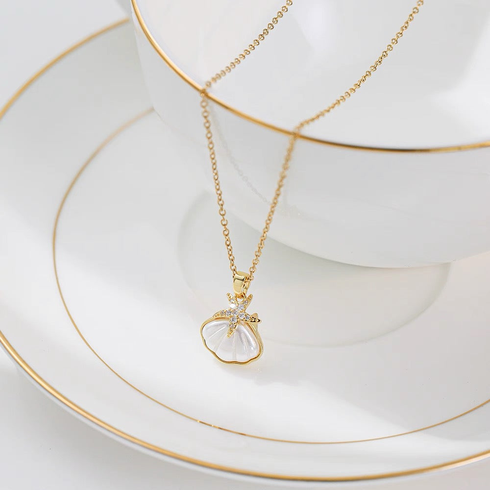 Ocean-inspired necklace with starfish and seashell charm