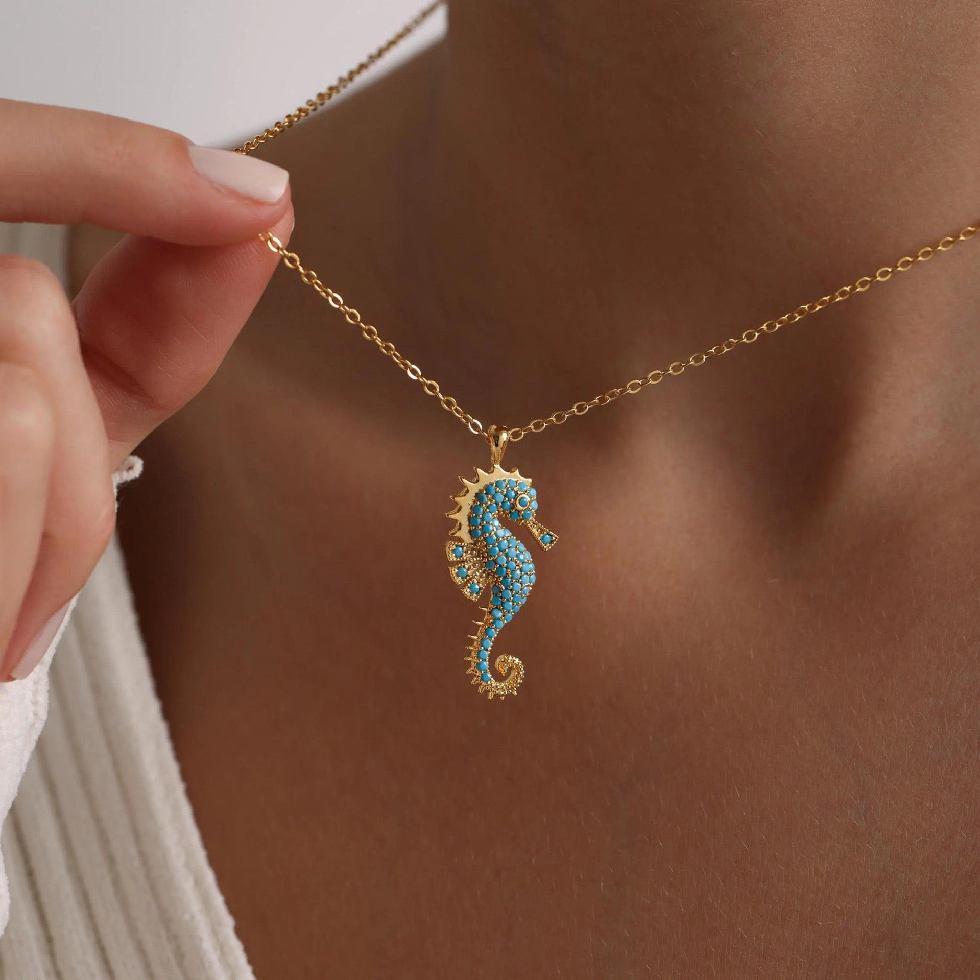 Model wearing Sea Horse Necklace, highlighting delicate details