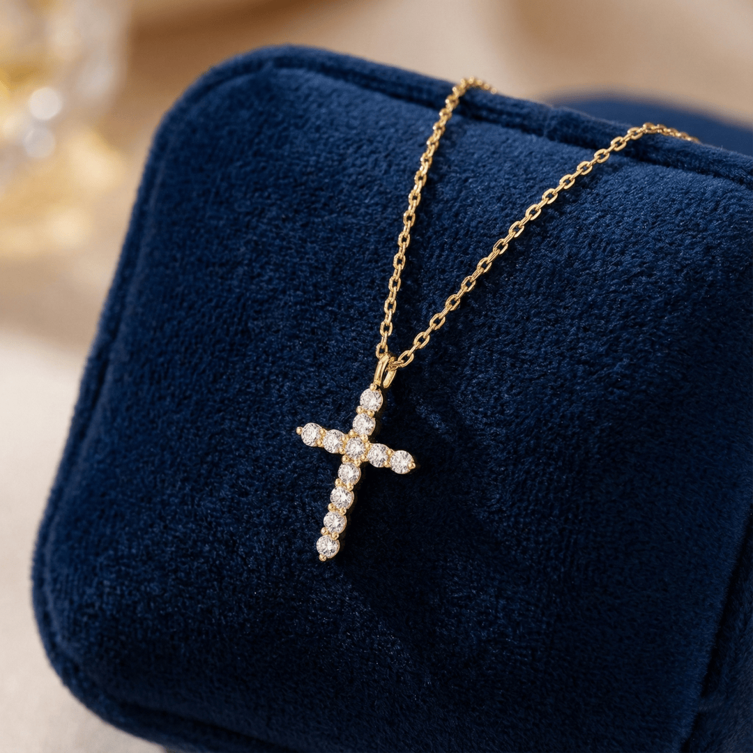 Close-up of polished 14K gold cross pendant showing smooth edges and fine craftsmanship