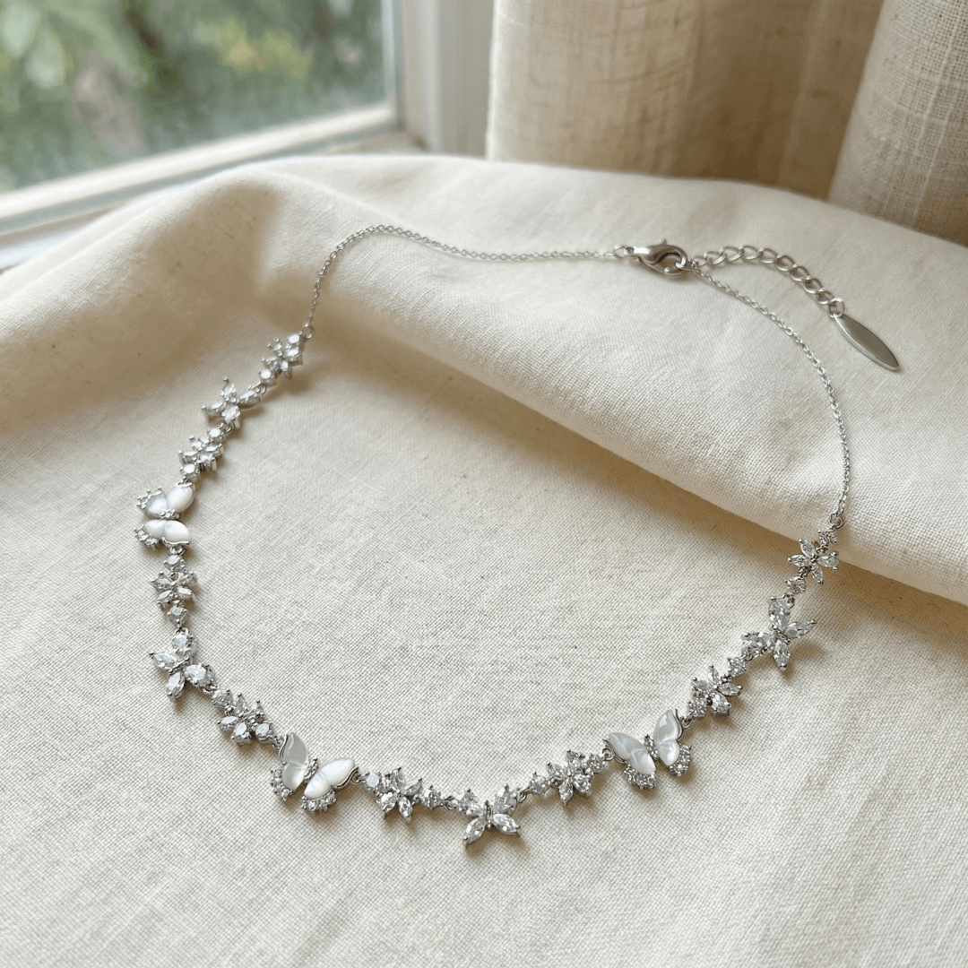 Close-up of CotaJewelry Butterfly Necklace sparkling with cubic zirconia and mother of pearl