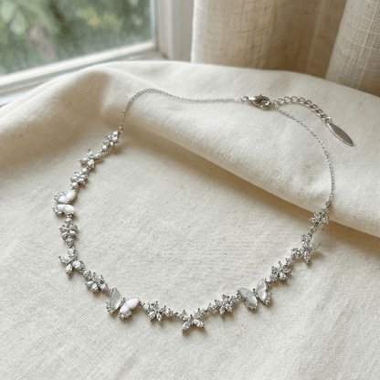 Close-up of CotaJewelry Butterfly Necklace sparkling with cubic zirconia and mother of pearl