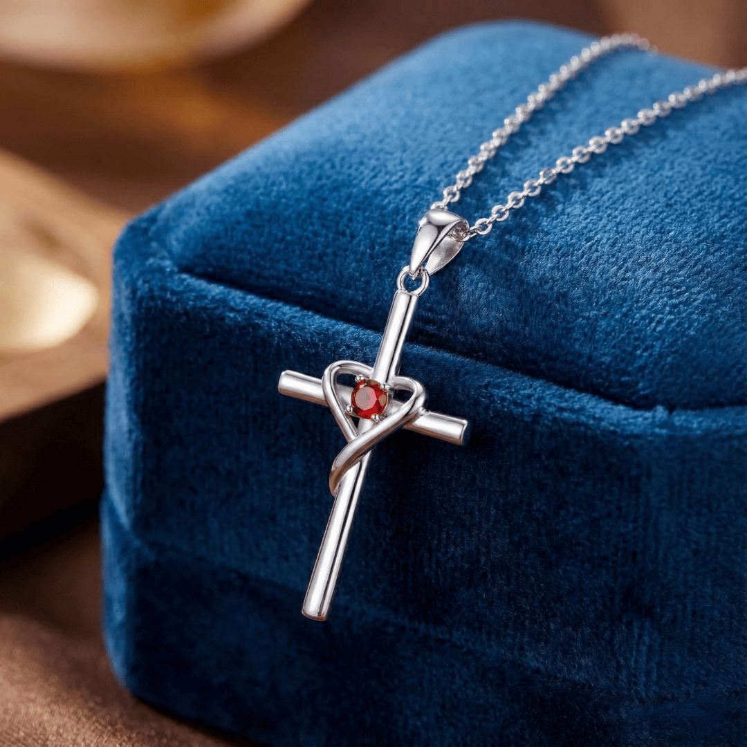 Close-up of sterling silver cross pendant featuring a genuine birthstone accent