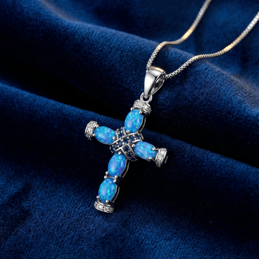 Close-up of opal cross pendant showing created opal color play and gold plated setting