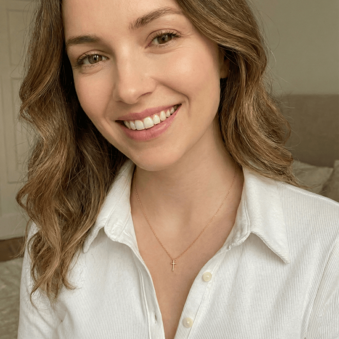 Model wearing minimalist gold cross pendant necklace for everyday elegant styling