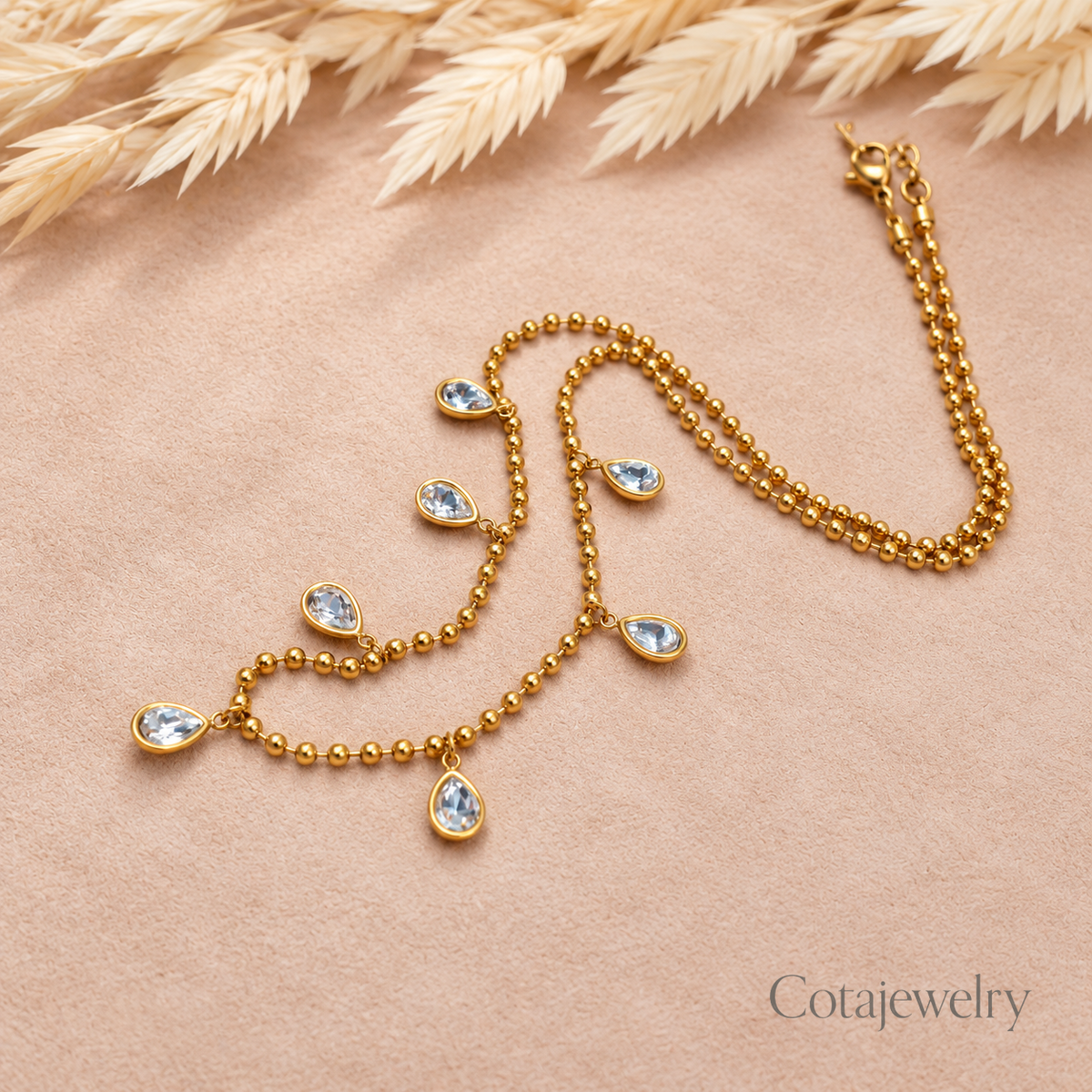 COTA Blue Charm Station Necklace in Gold Tone